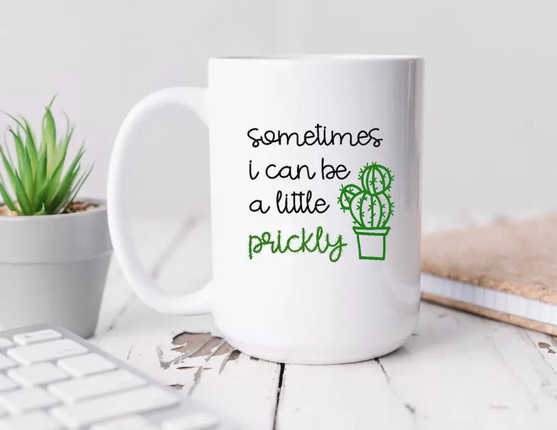 White ceramic mug with green cactus design and "sometimes I can be a little prickly" text, perfect for quirky gifts.