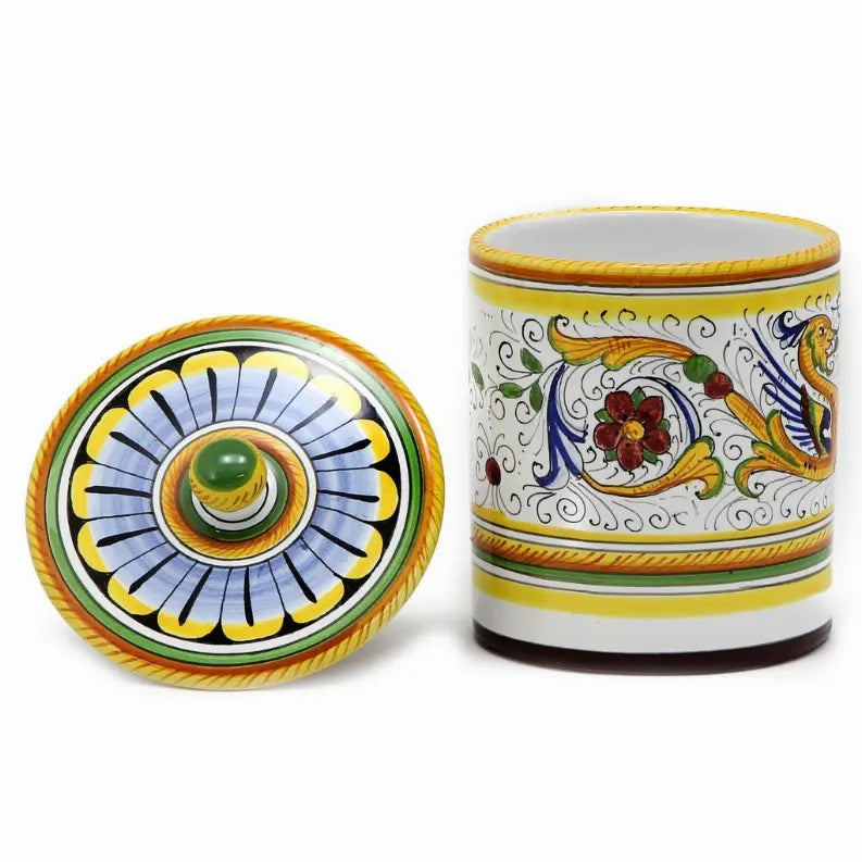 Hand-painted ceramic canister in blue, yellow, and green with floral designs and a decorative lid.