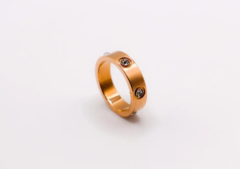 Rose gold ring with two clear cubic zirconia gemstones; sleek, modern design for everyday elegance.