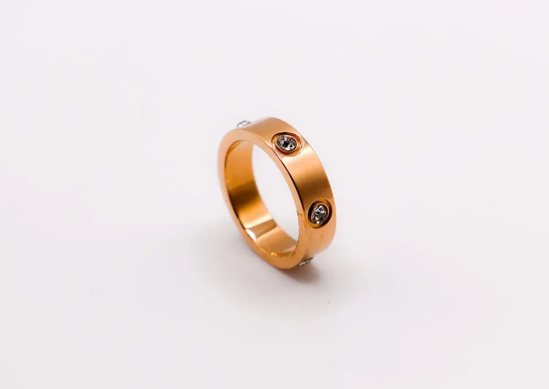 Rose gold ring with two clear cubic zirconia gemstones; sleek, modern design for everyday elegance.