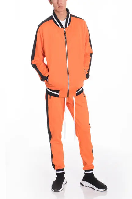 Men's orange tracksuit with black accents, made of lightweight fabric, featuring a zip-up jacket and drawstring pants.