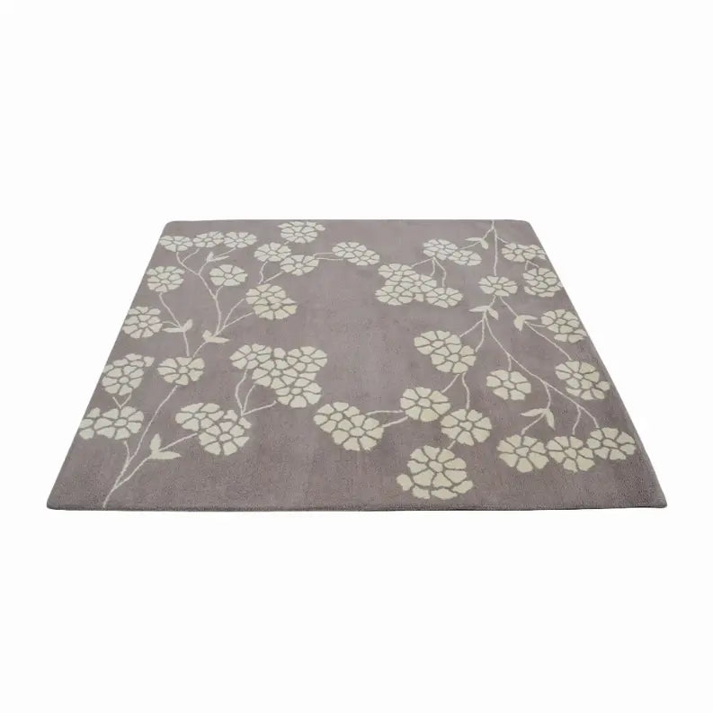 Gray floral area rug with ivory flowers, plush material, and modern design for stylish home decor.