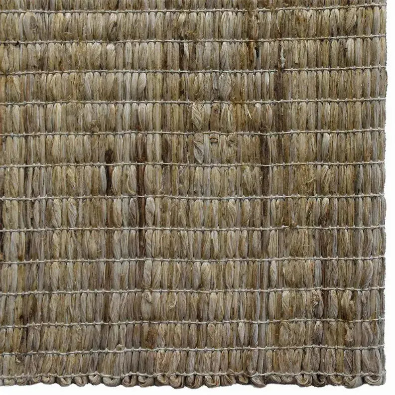 Natural jute area rug in earthy beige tones, handwoven with a textured, rustic style for cozy interiors.