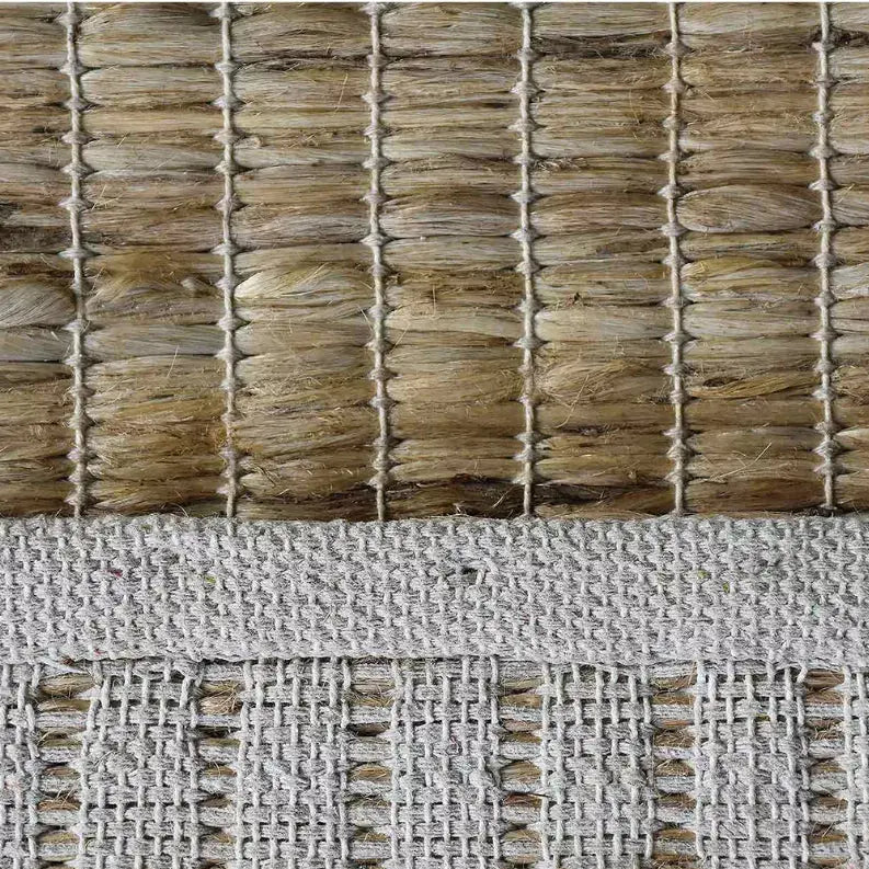 Natural jute and beige cotton woven rug with textured pattern, perfect for bohemian or rustic home decor.