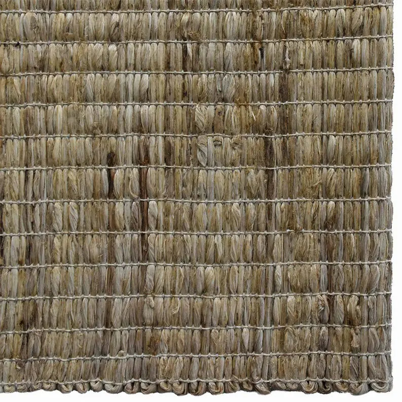 Natural woven jute rug in earthy beige tones, featuring a textured, rustic style perfect for home décor.