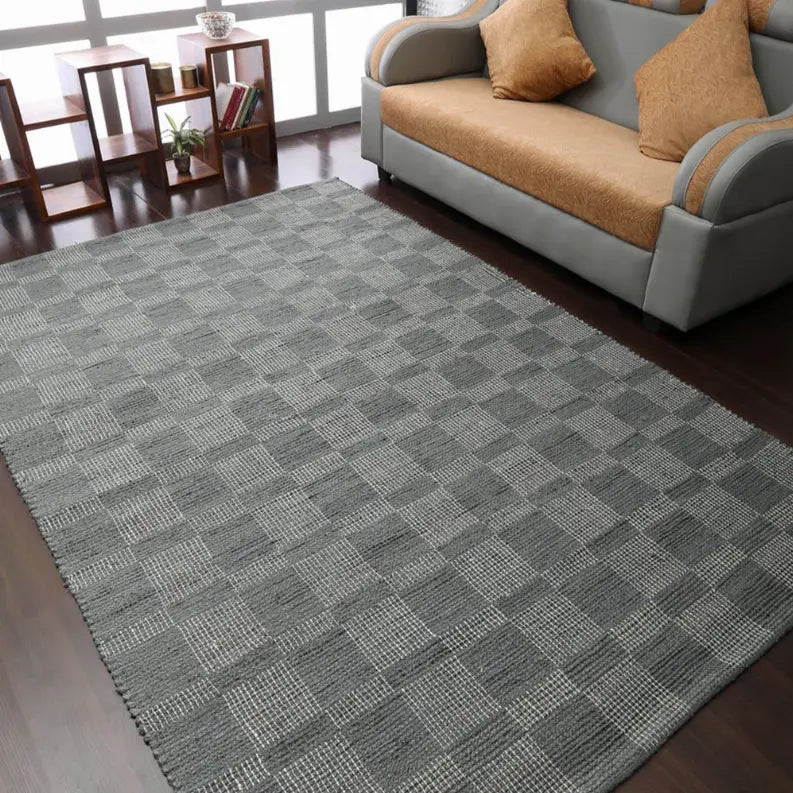 Gray woven checkered area rug, soft texture, modern design, ideal for living room decor.