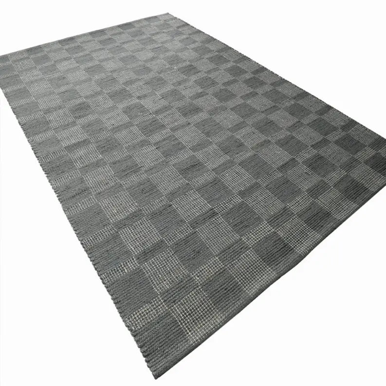 Gray woven area rug with a classic checkered pattern, perfect for modern or minimalist decor.