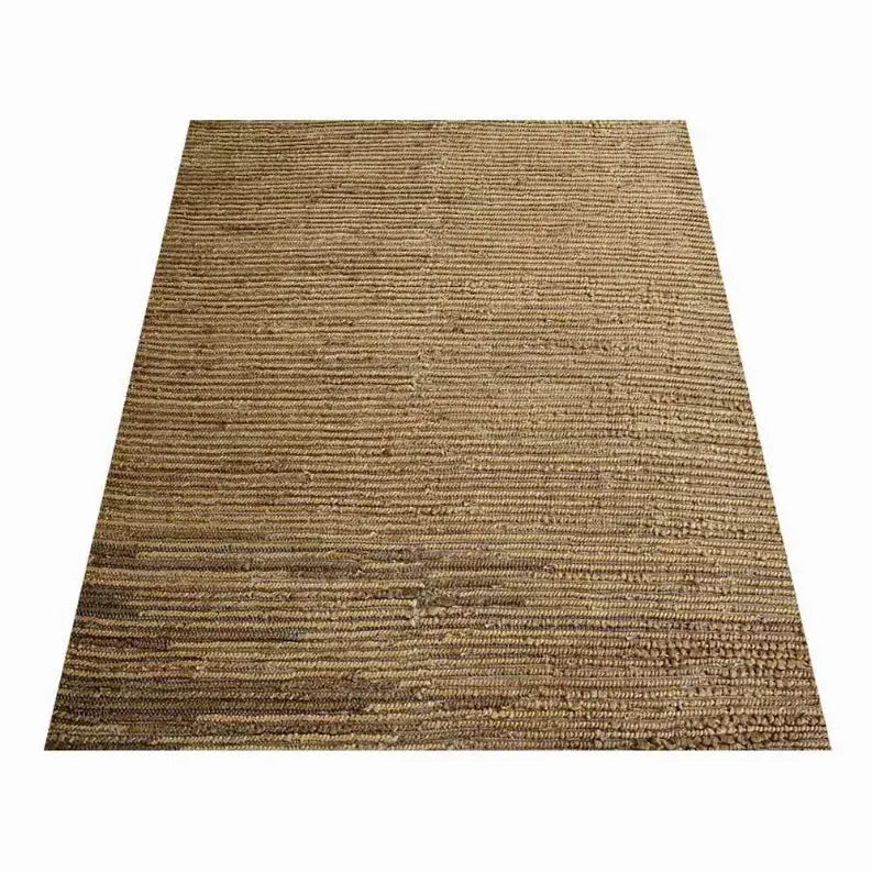 Tan woven jute rug featuring a textured striped design, perfect for rustic or bohemian home decor.