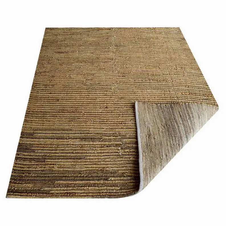 Natural jute area rug in earthy tones with a textured, striped design, ideal for rustic or bohemian decor.