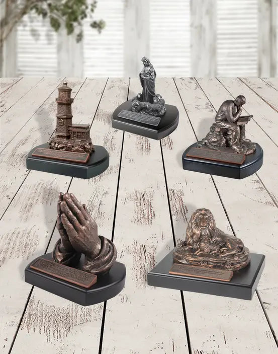 Set of 4 bronze sculptures: lighthouse, praying hands, reader, and contemplative figure on black bases.