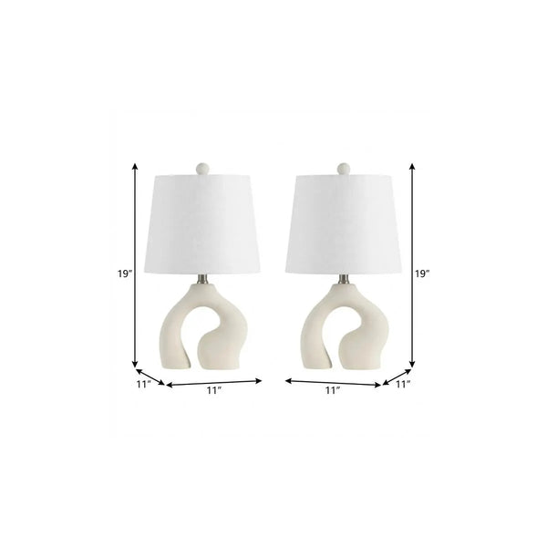 Set of 2 white ceramic lamps with curved base and fabric shades, 19" tall, modern home decor accent.