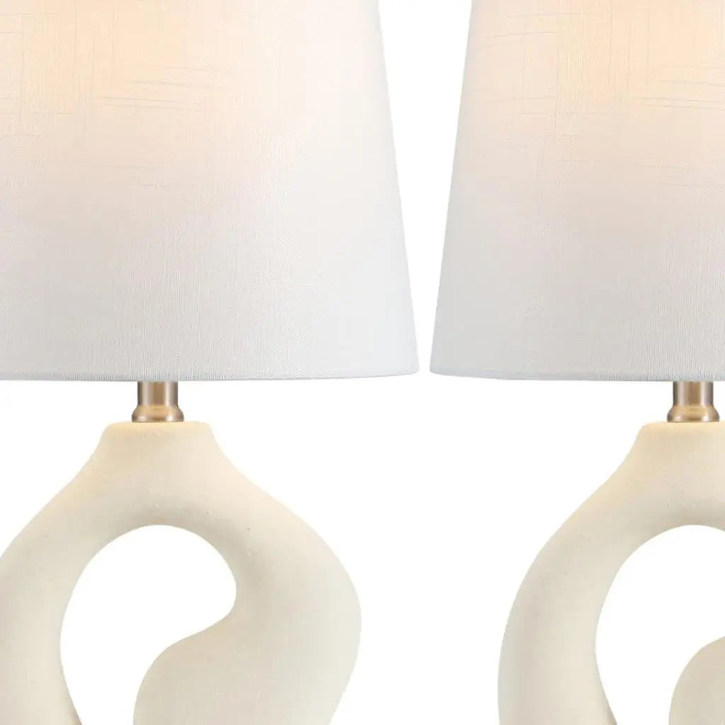 White ceramic decorative lamp set with textured ivory fabric shades and gold accents, perfect for modern interiors.