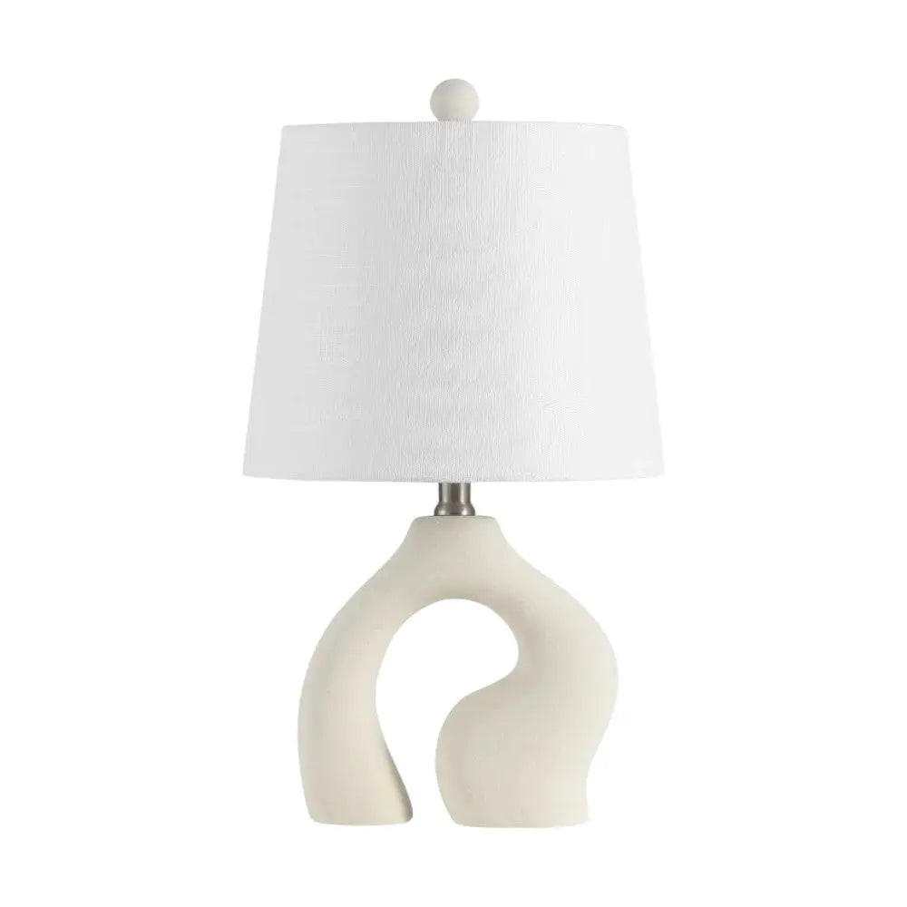 White ceramic lamp with modern curved design and a textured fabric shade. Perfect for contemporary decor.