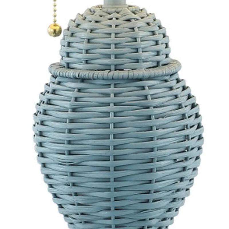 Light blue woven wicker lamp with a decorative pull chain and rounded shape, perfect for coastal-inspired decor.