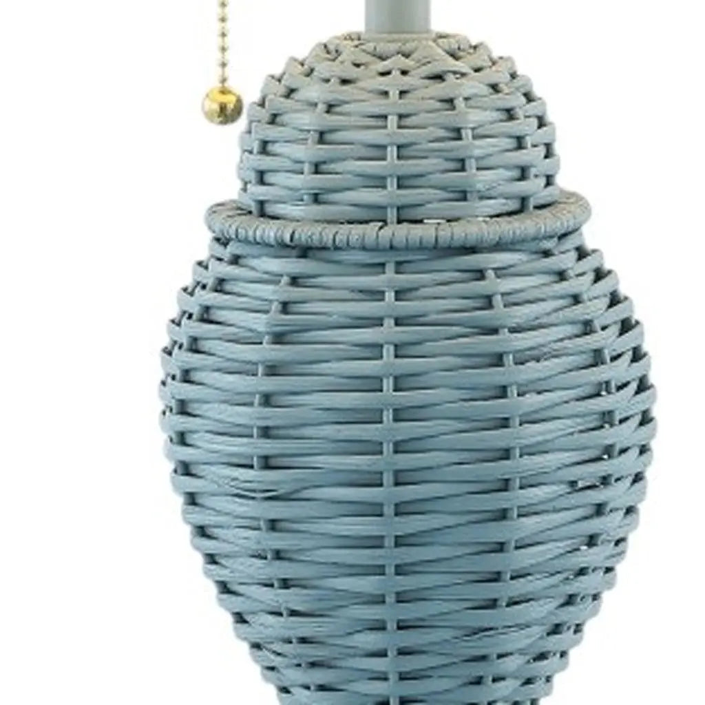 Blue woven table lamp with a unique oval shape and a decorative pull chain. Perfect for modern decor.