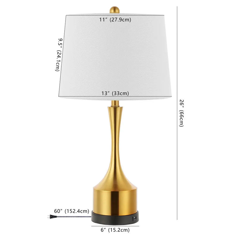 Modern gold table lamp with a white fabric shade, 26” tall, sleek design, and USB charging port.
