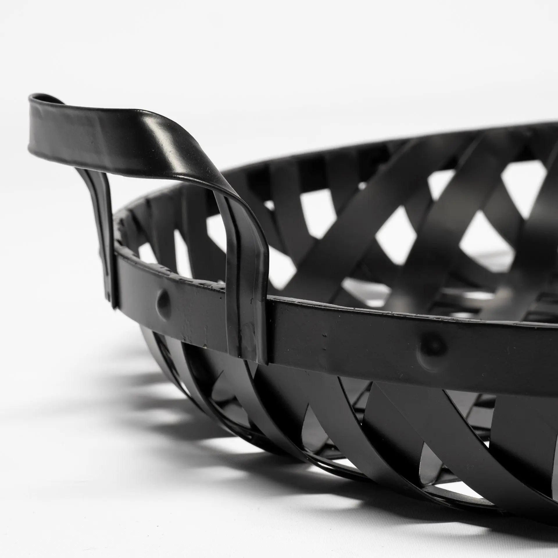 Black metal woven basket with handles, stylish and modern design for home organization and decor.