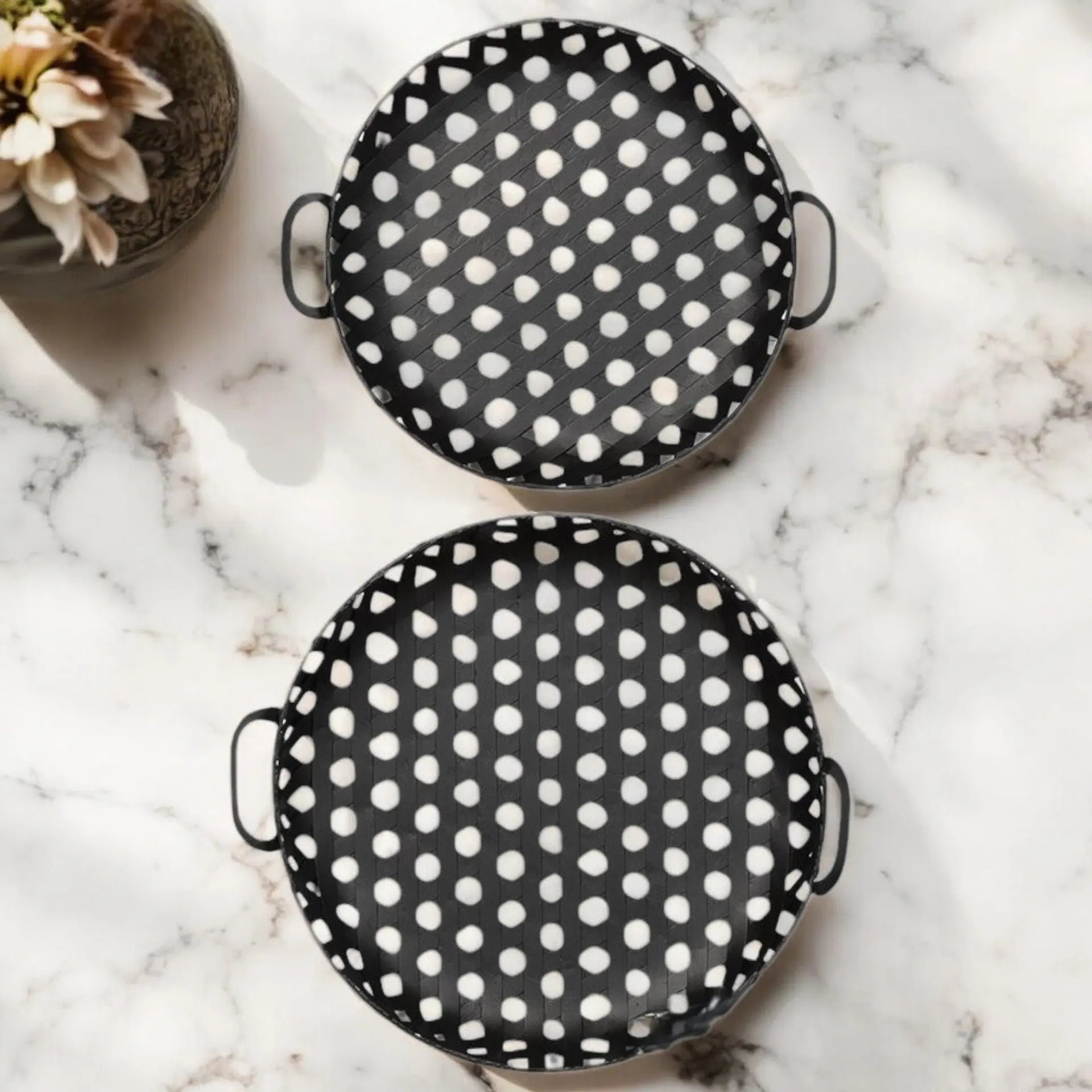 Black and white polka dot serving trays made of ceramic with sturdy handles, perfect for stylish entertaining.