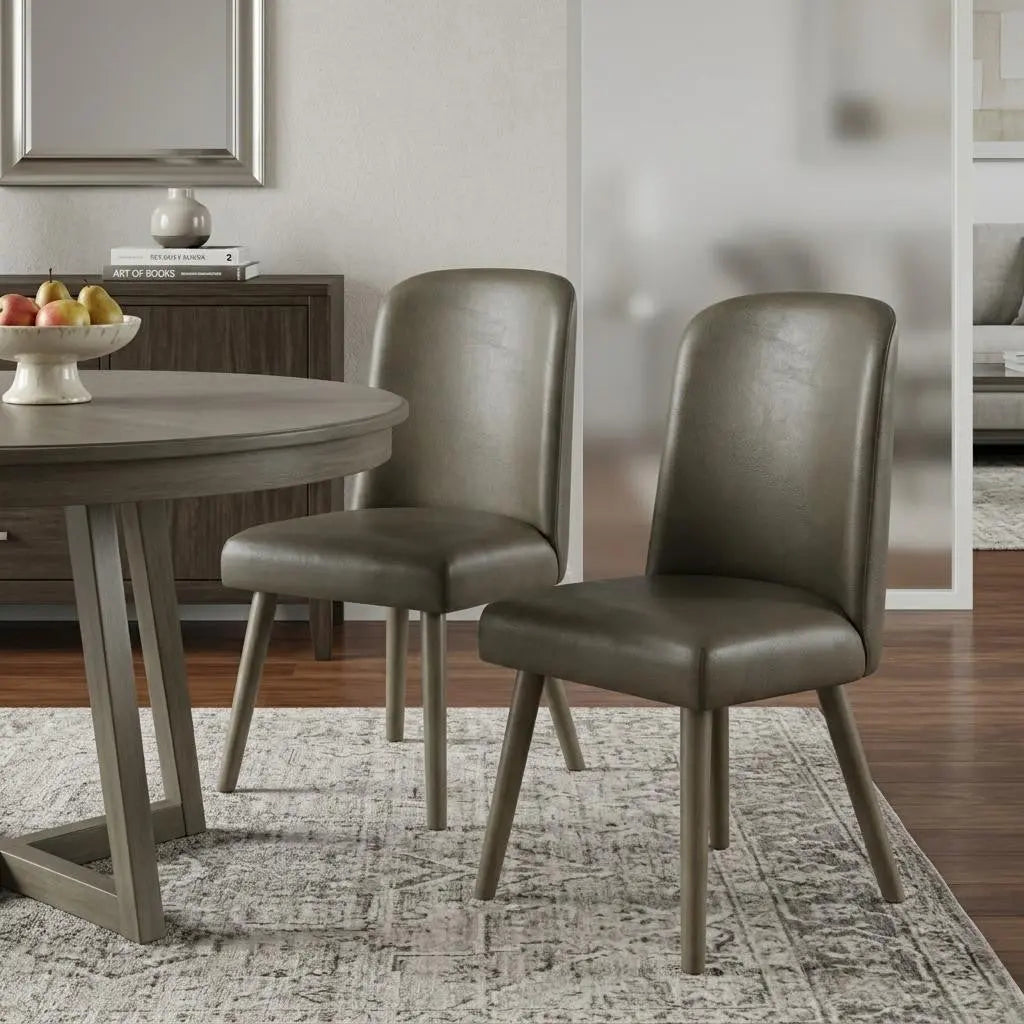 Dark olive green faux leather dining chairs with tapered wooden legs, stylishly accenting a modern dining room.
