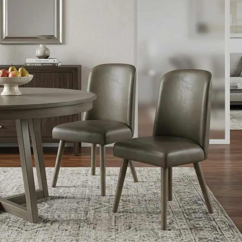 Dark olive green faux leather dining chairs with tapered wooden legs, stylishly accenting a modern dining room.