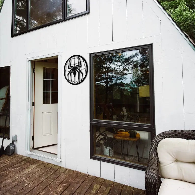Black spider web wall decor, made of metal, perfect for modern outdoor aesthetics, enhancing entryways and patios.