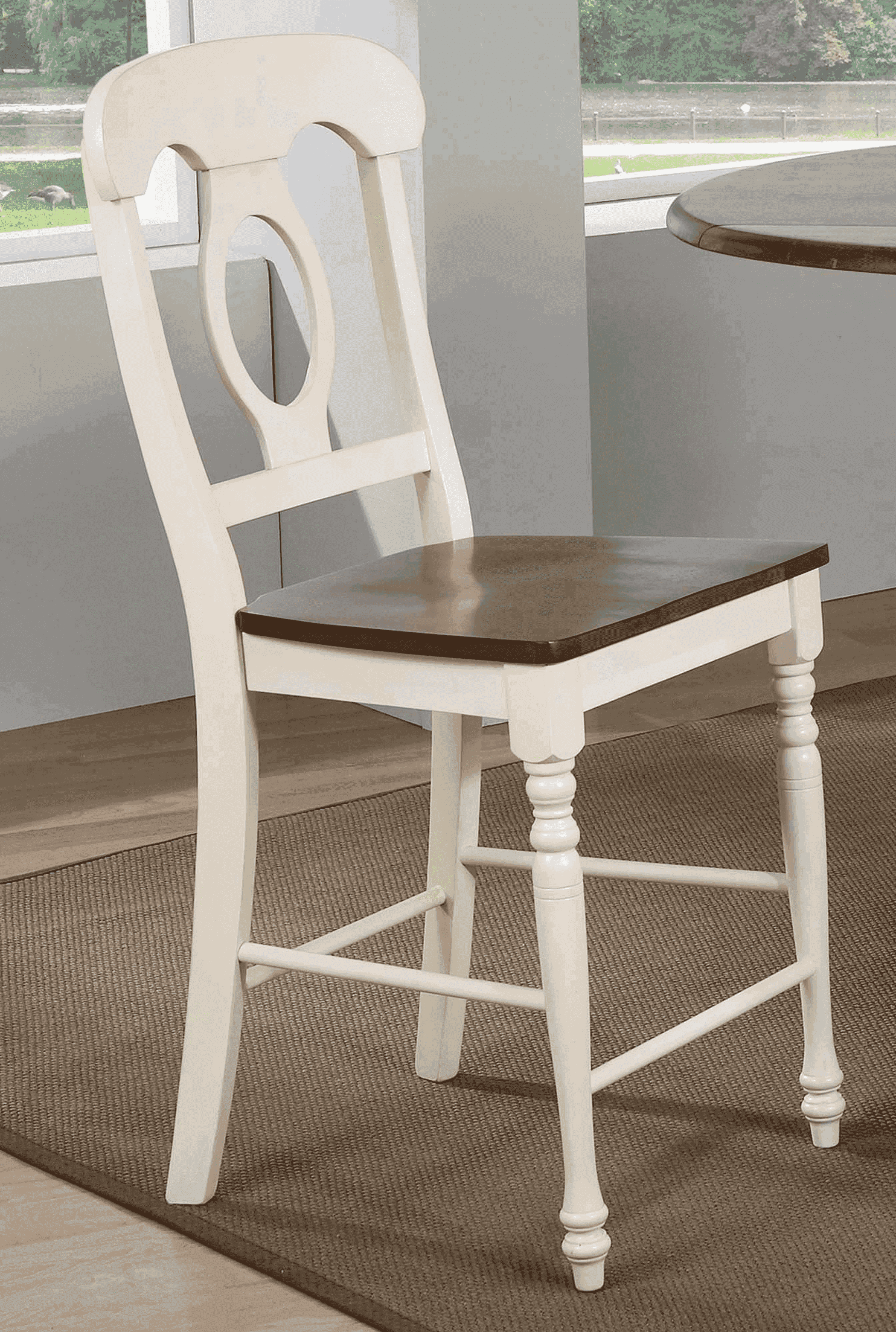 Cream wooden dining chair with a brown wood seat and classic design, featuring a carved oval backrest and turned legs.