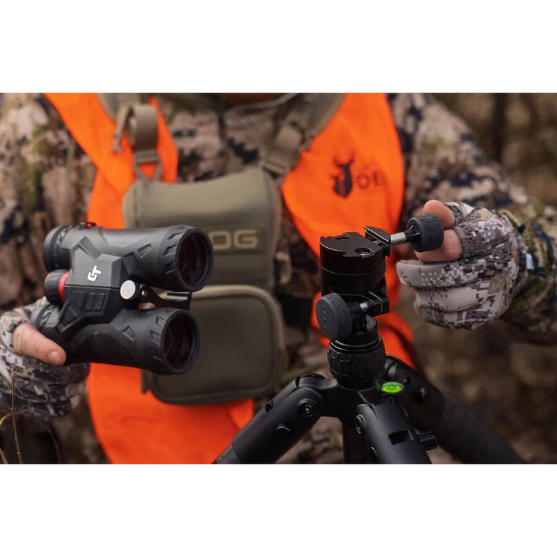 Tripod head close-up with adjustment knobs and black legs for mounting an optic