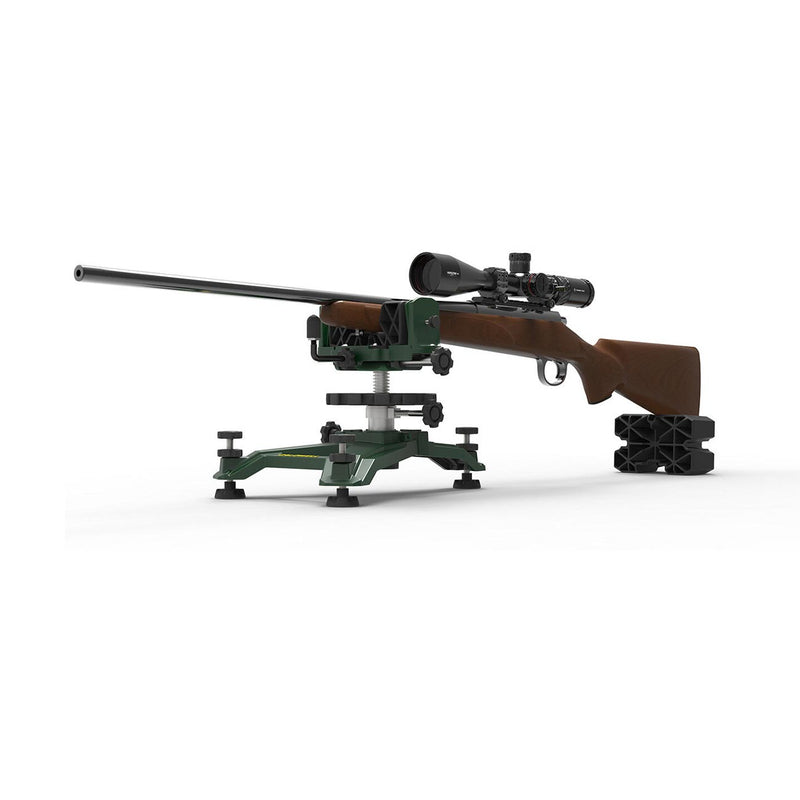 Shooting rest with rifle mounted on green base and black stabilizing blocks.