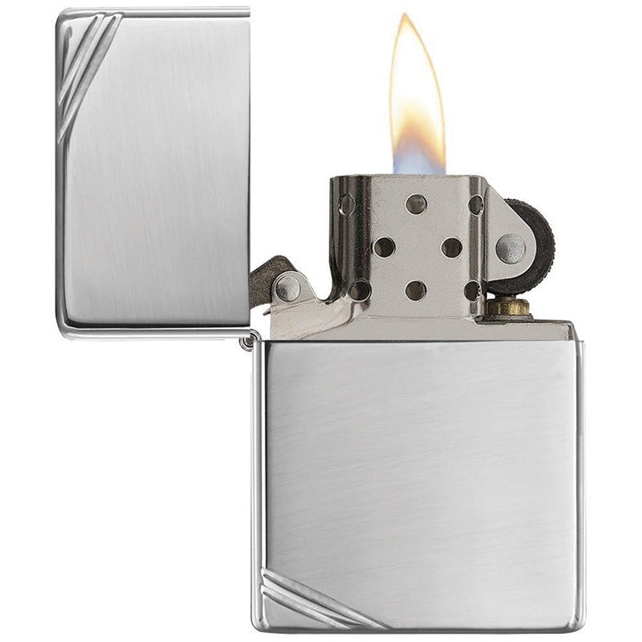 Zippo windproof lighter with raised flame, chrome body and slashed engraving