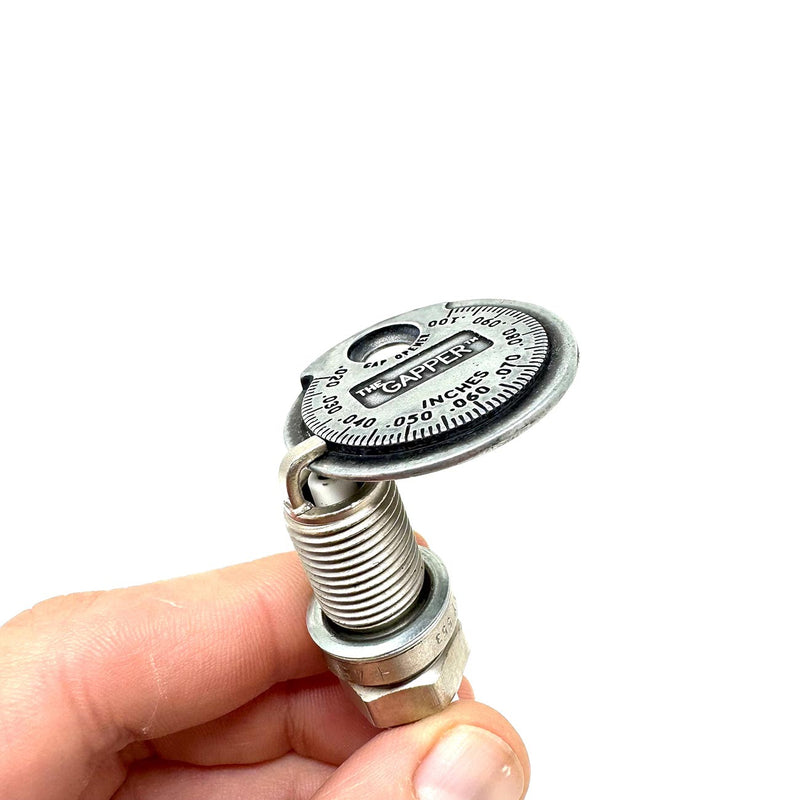 Spark plug gapper tool on threaded metal post with dial top and inches scale