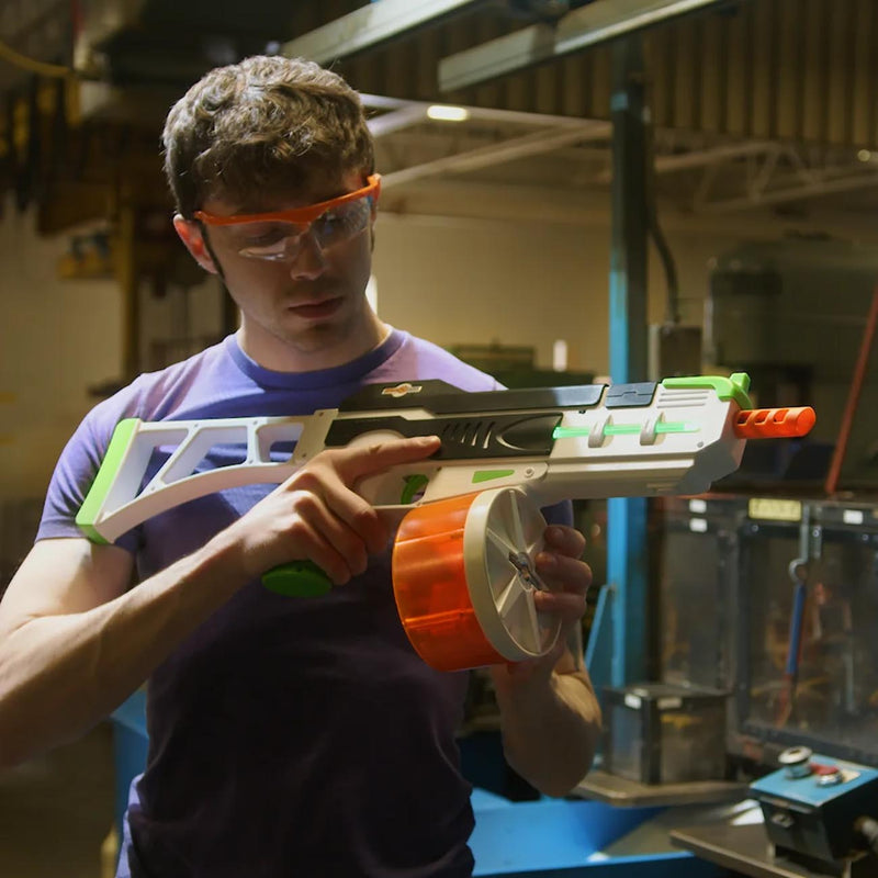Orange 800-round drum magazine attached to toy blaster