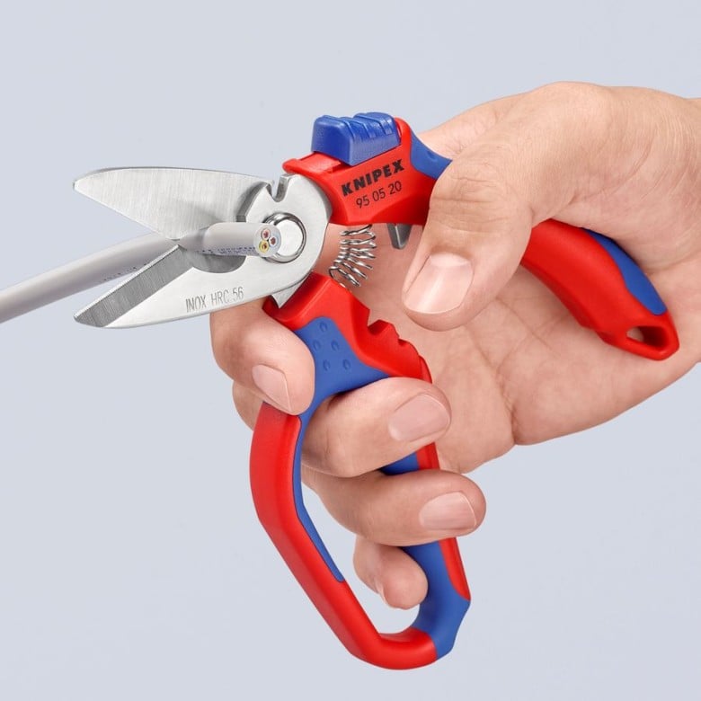 Knipex angled electricians' shears in hand, red/blue ergonomic handles and spring