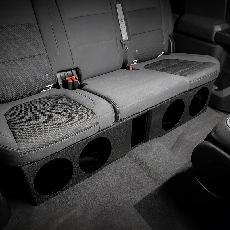 Woofer enclosure installed in the rear seat area with four circular speaker openings.