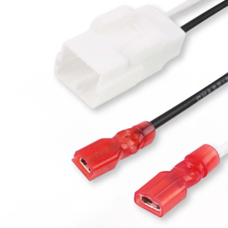 OEM speaker wiring harness close-up: white plug with red speaker terminals on black wires
