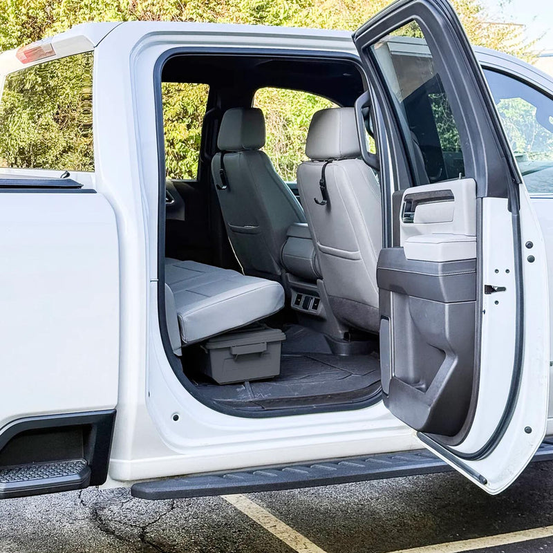 Open truck door showing rear bench area with under-seat storage crate installed