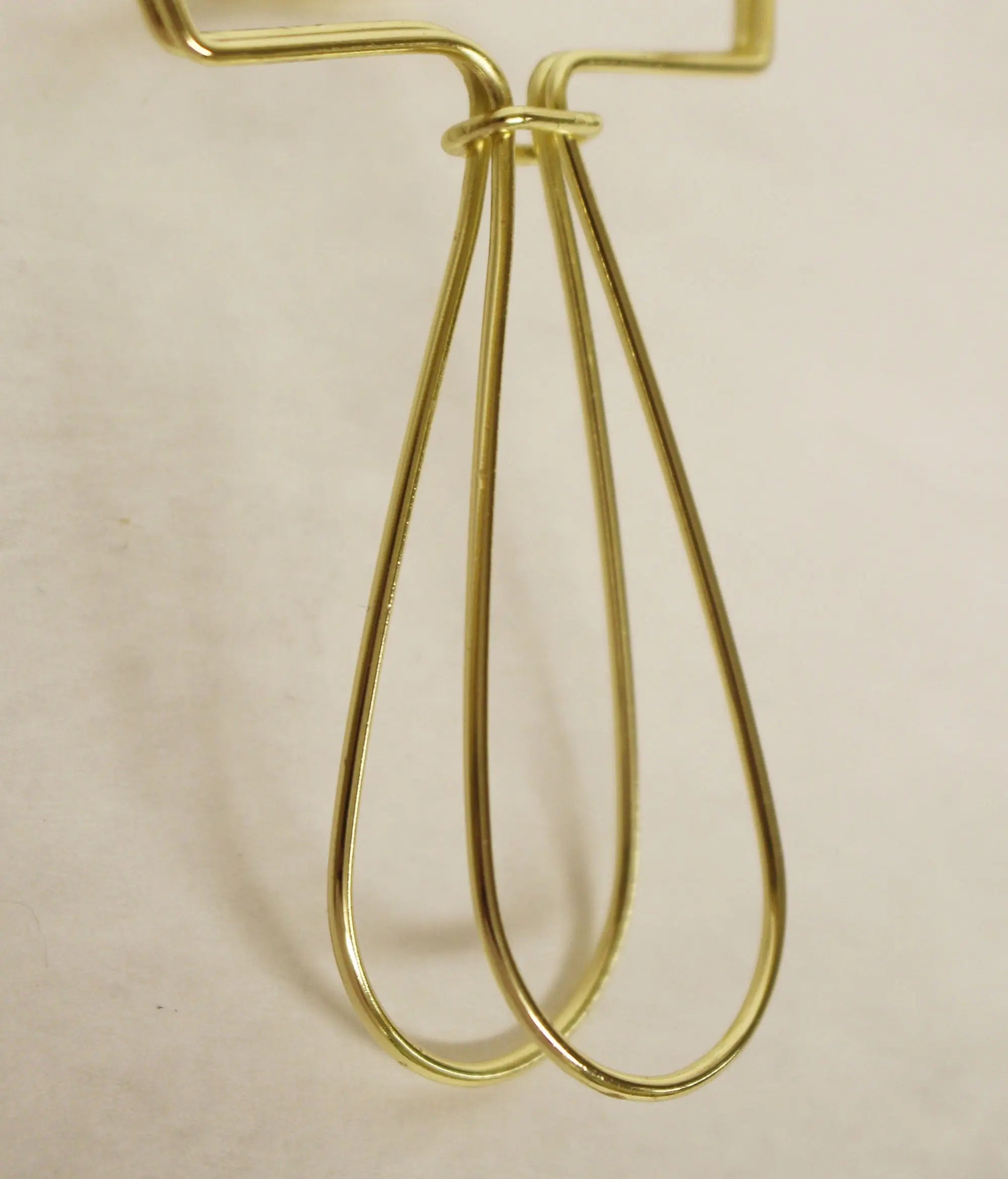 Gold stainless steel whisk with a sleek, modern design and comfortable grip for efficient mixing and whisking.