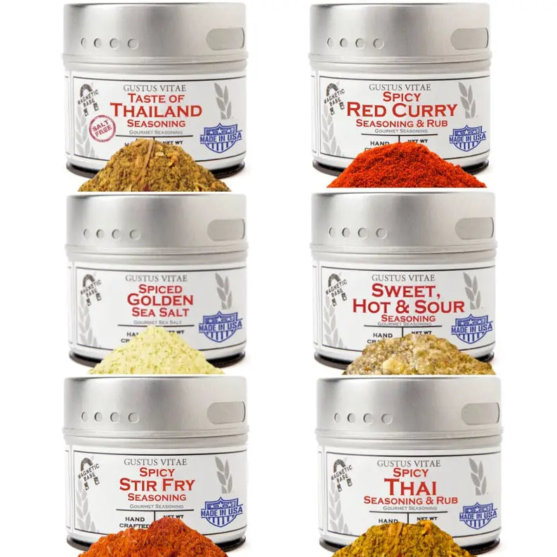 Gustus Vitae spice seasoning set: Thai, red curry, stir fry, and sweet hot & sour; vibrant colors in sleek metal tins.