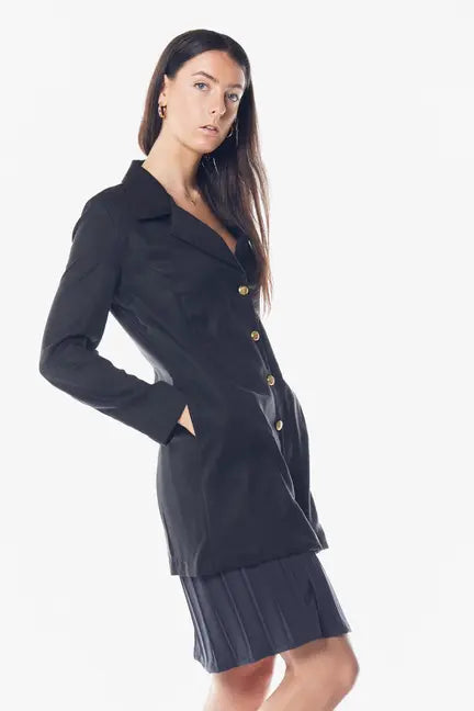 Black tailored blazer with gold buttons, made from soft fabric, styled with a pleated skirt for a chic look.
