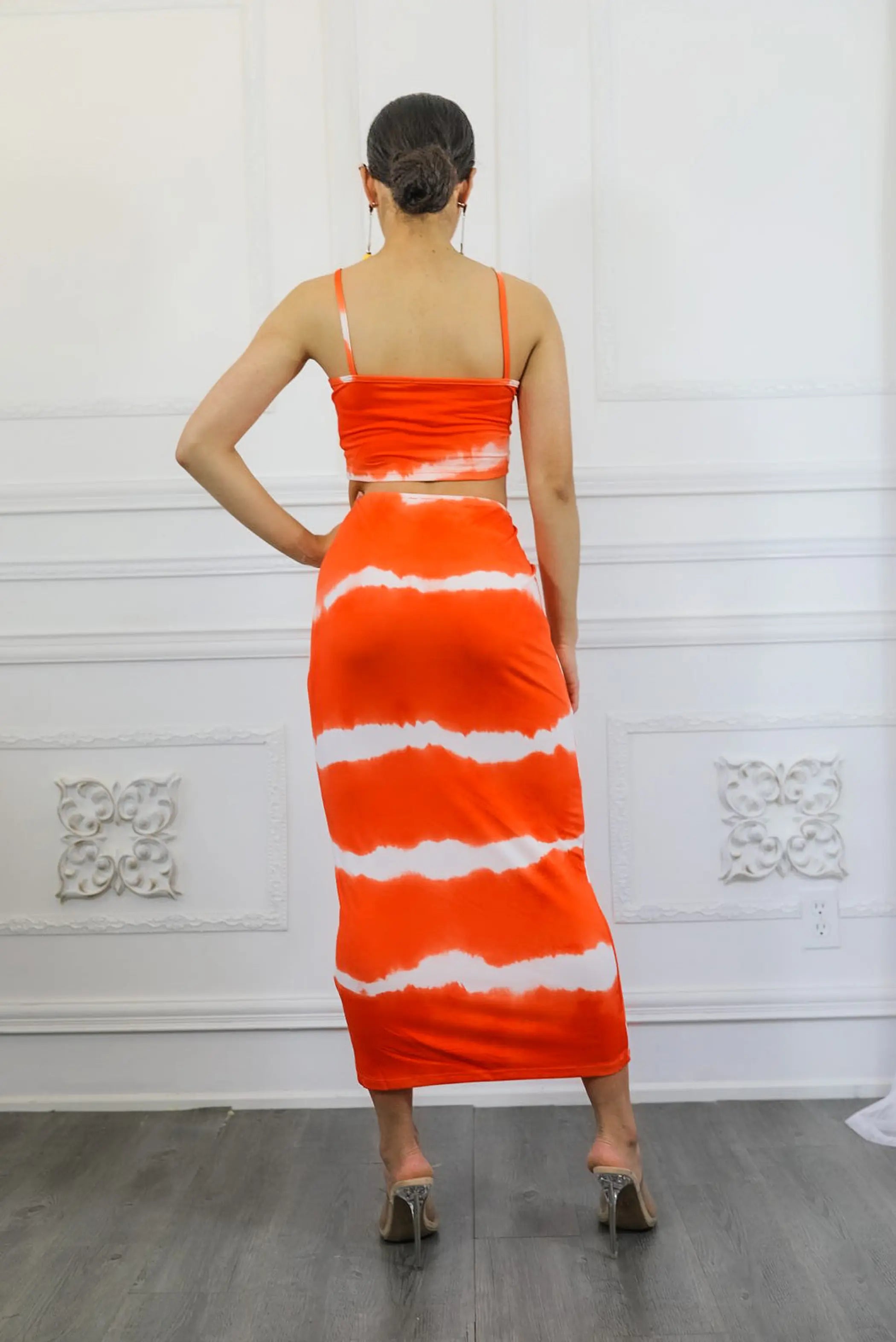 Orange and white tie-dye maxi dress with spaghetti straps, fitted silhouette, and soft jersey material.