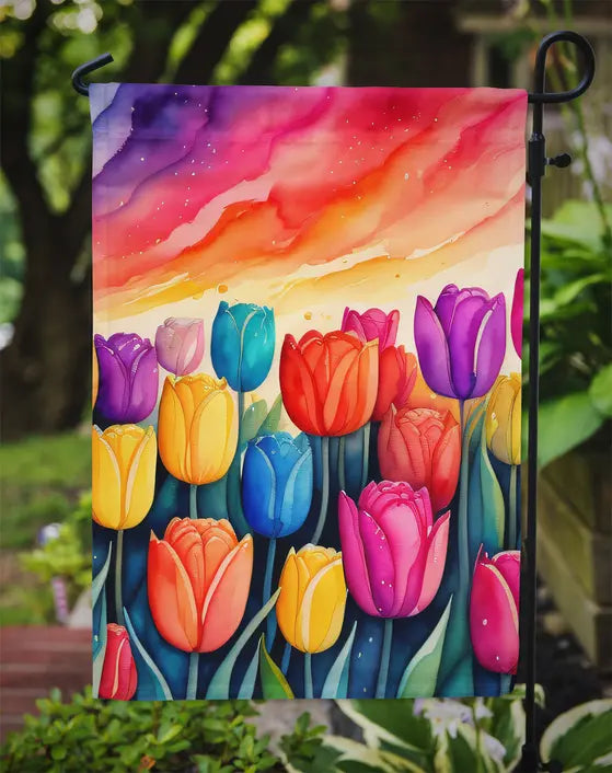Vibrant tulip garden flag, featuring colorful blooms in purple, yellow, and red on a watercolor sunset backdrop.