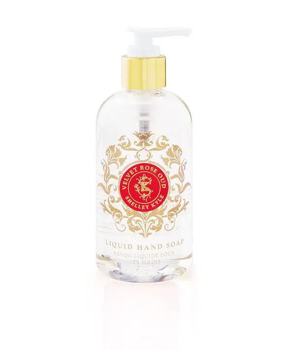 Clear bottle of Velvet Rose Oud liquid hand soap with golden floral design and pump, perfect for luxurious hand care.