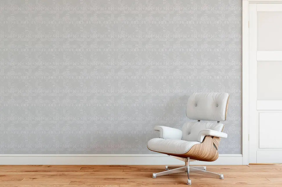 Modern white leather chair with wood accents against a textured light gray patterned wall in a stylish interior setting.
