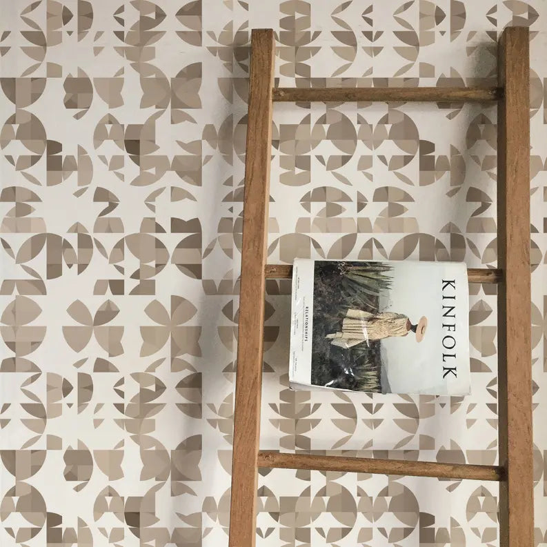 Beige abstract patterned wallpaper with wooden ladder and magazine, adding stylish decor to any interior space.