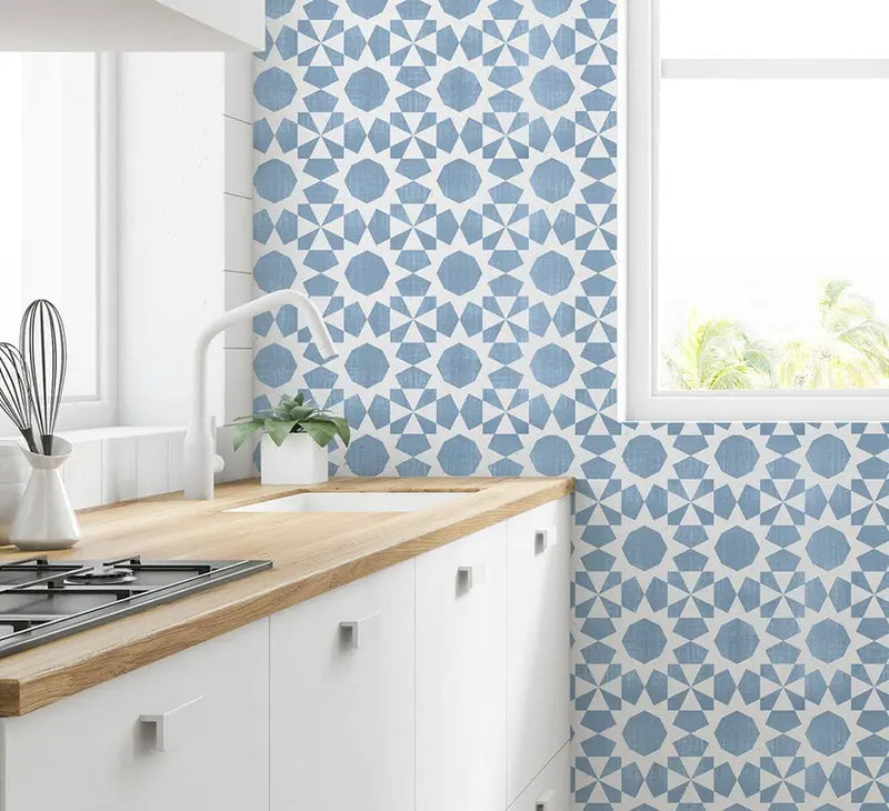 Light blue geometric tile wallpaper in a modern kitchen setting, featuring a stylish star pattern against a white backdrop.