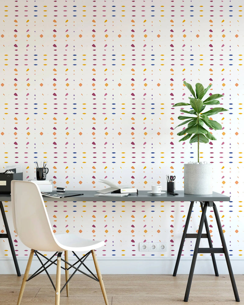 Colorful geometric pattern wallpaper in white, featuring yellow, pink, and blue shapes, perfect for modern home decor.