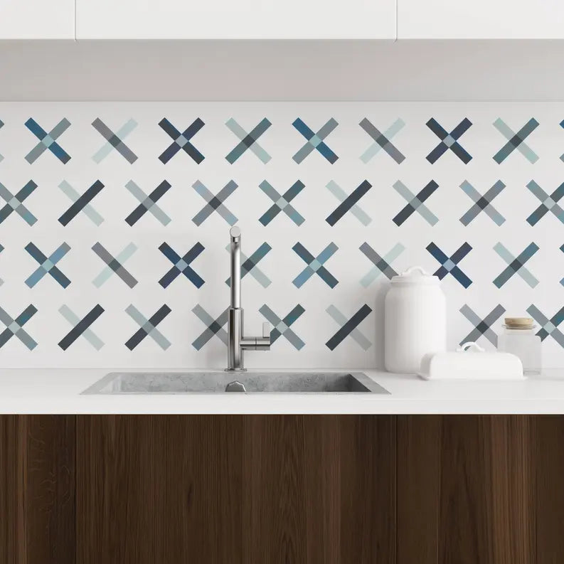Blue and gray geometric patterned backsplash tile for modern kitchens, complements white cabinetry and wood accents.