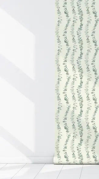 Light green leafy pattern wallpaper on a cream background, perfect for adding a natural touch to modern interiors.
