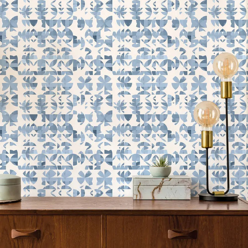Blue and white botanical patterned wallpaper with modern design, styled in a cozy living room setting.