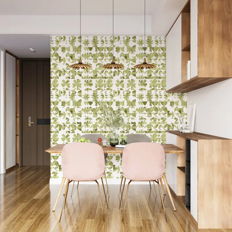 Green botanical wallpaper with gold pendant lights, pink chairs, and wooden accents in a modern dining space.