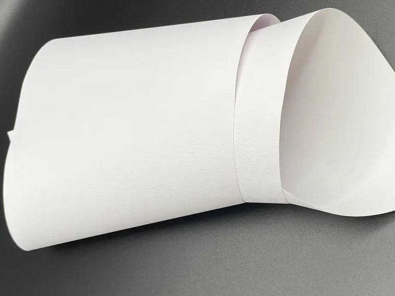 White textured paper roll with a smooth finish, ideal for crafting and DIY projects.